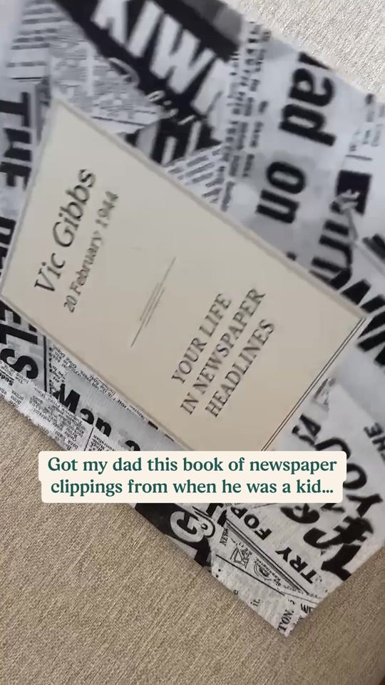 A newspaper headlines book on a table, caption: Got my dad this book